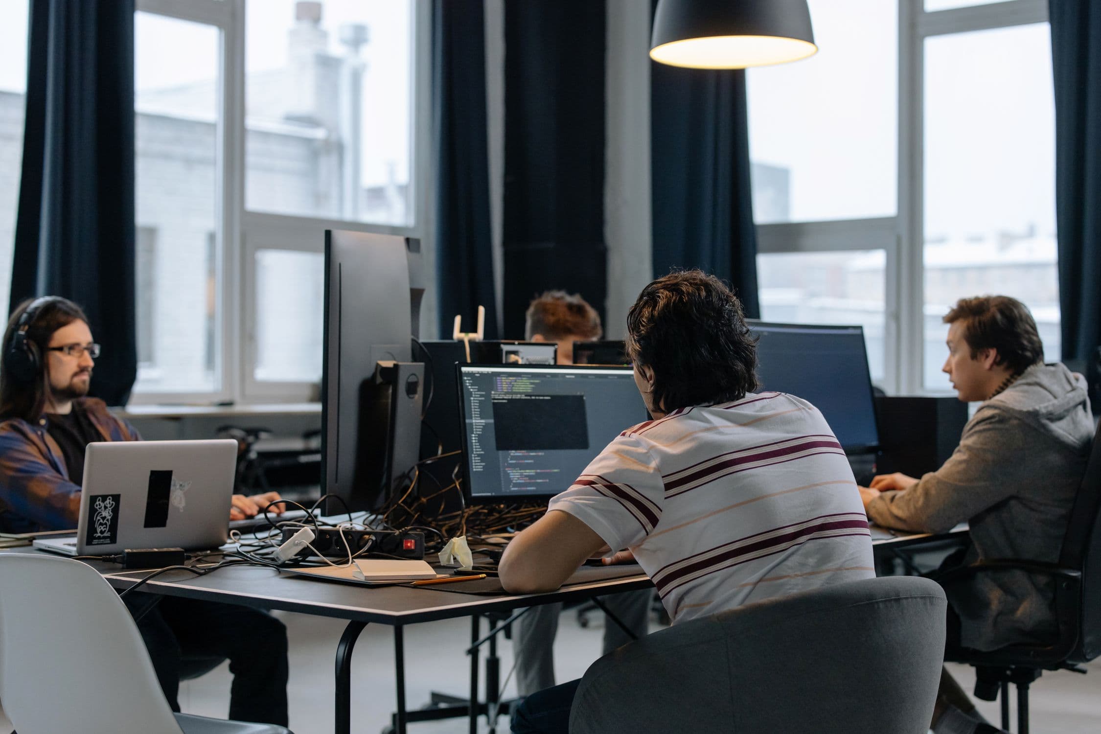 Software development team collaborating on AI project - representing outsourced AI development for enterprise clients