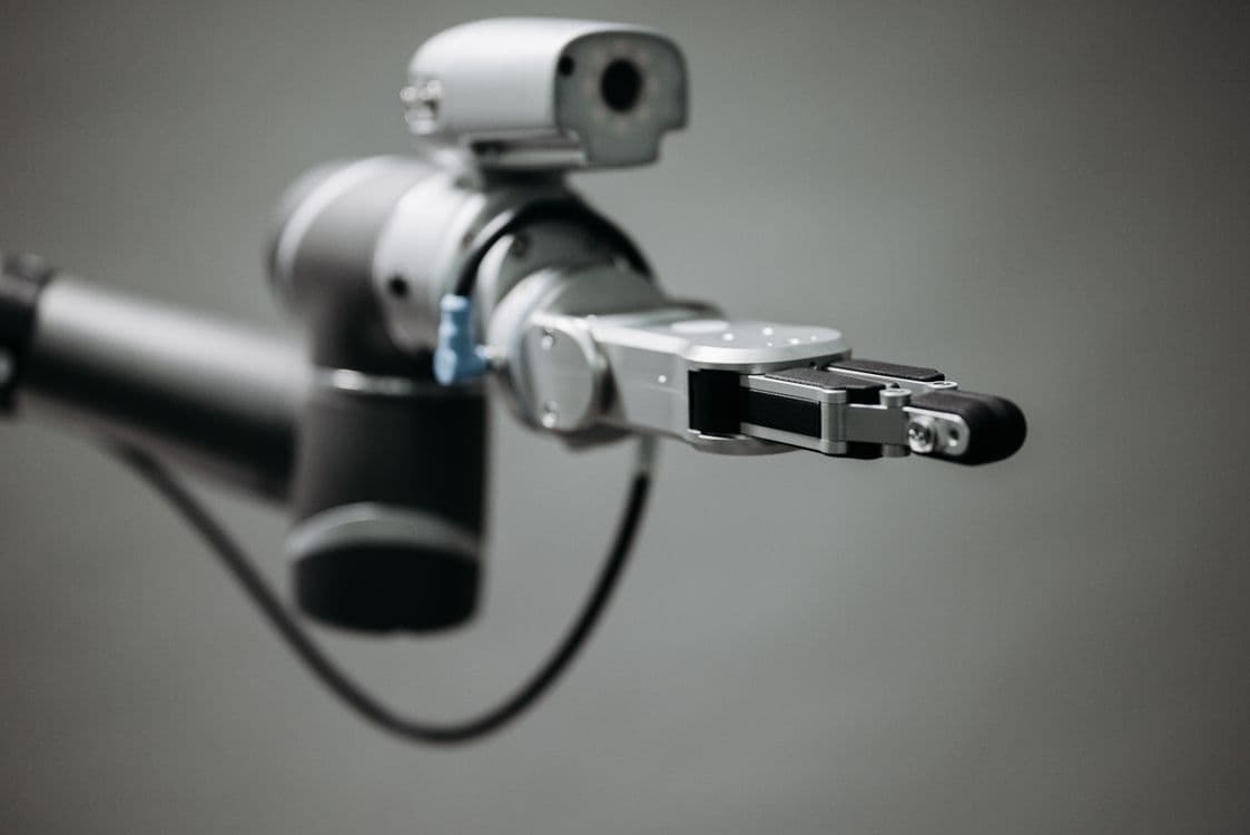 Robotic arm performing precision teleoperation task - representing managed teleoperation data collection service for robot AI training programs