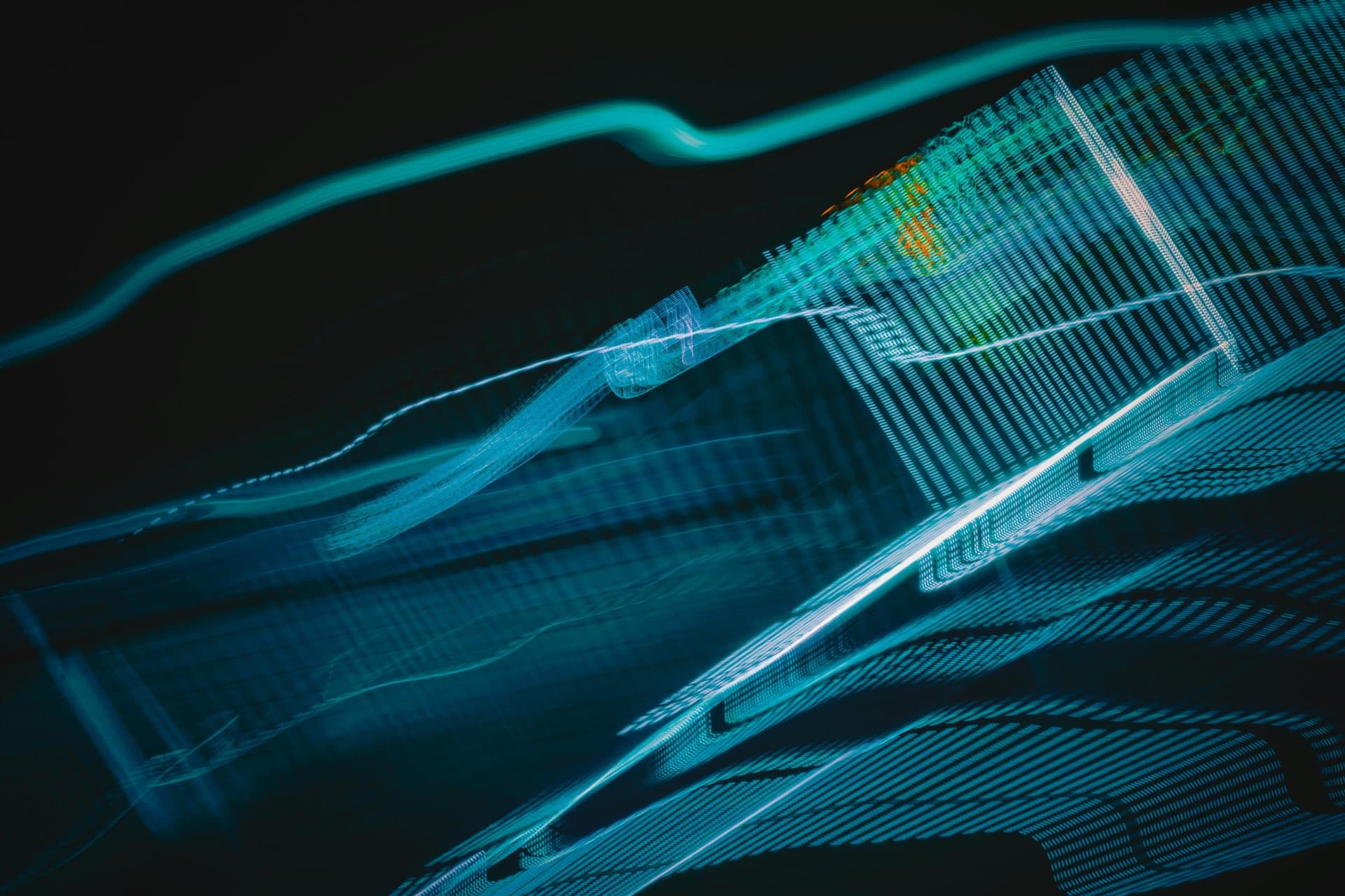 Abstract teal and cyan light trails representing flowing data