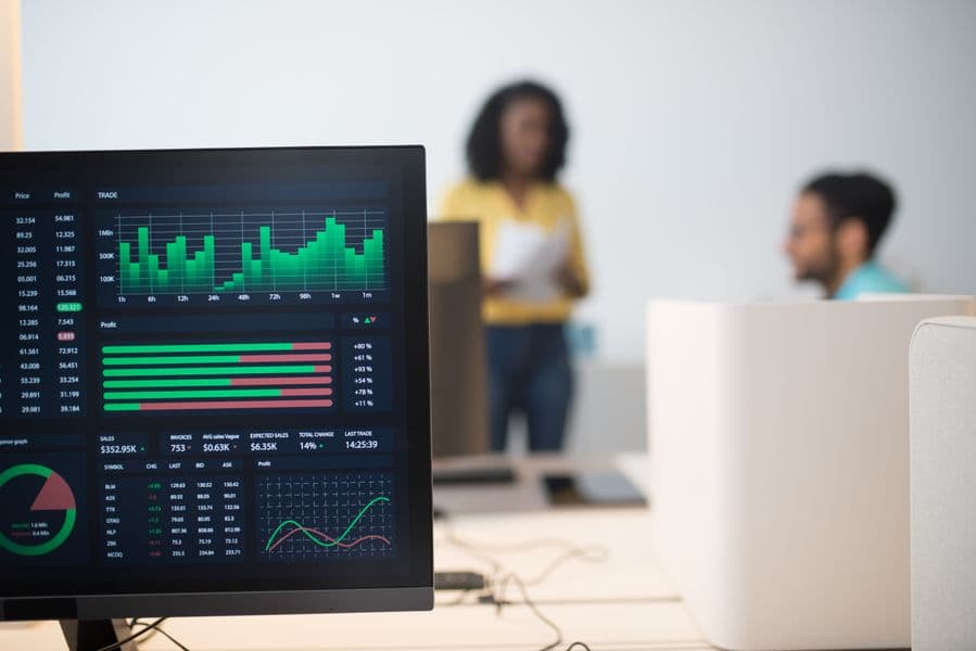 Team analyzing data on large screens in a modern office