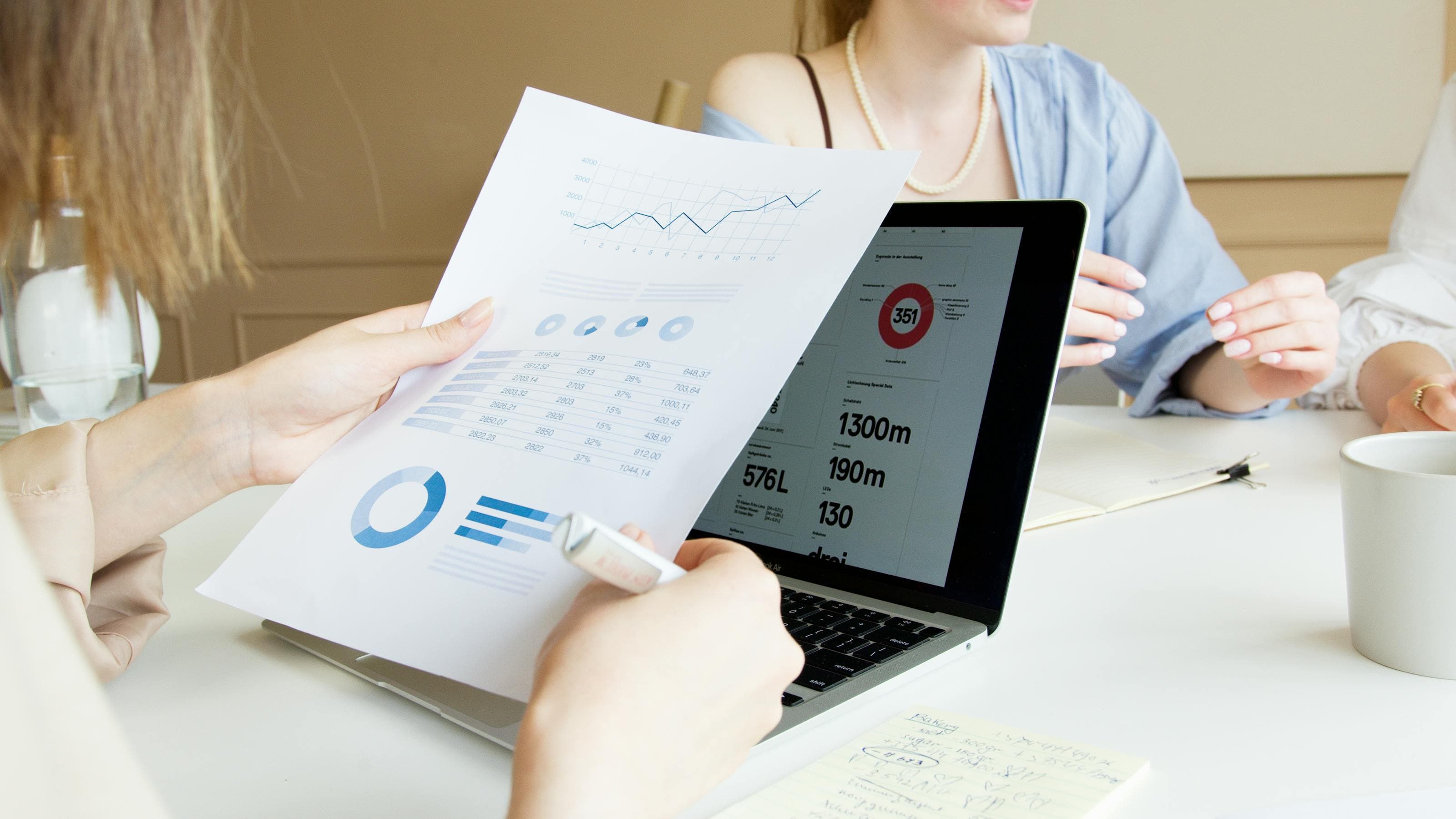 Two specialists reviewing labelled data on a laptop – auditing data annotation quality to cut the downstream cost of bad labels in AI training