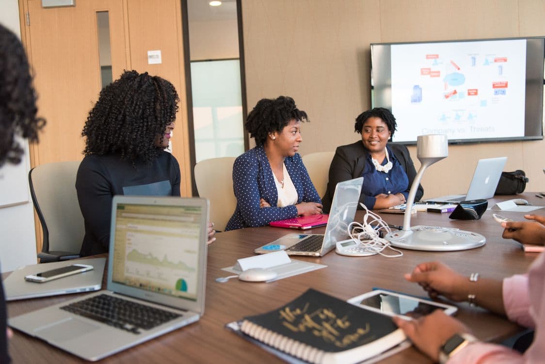 Enterprise AI team evaluating data collection vendors around a laptop in a tech office